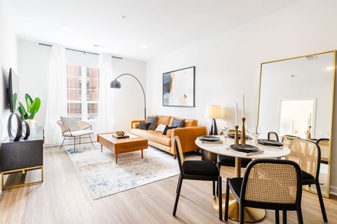 a living room with a round table and a couch